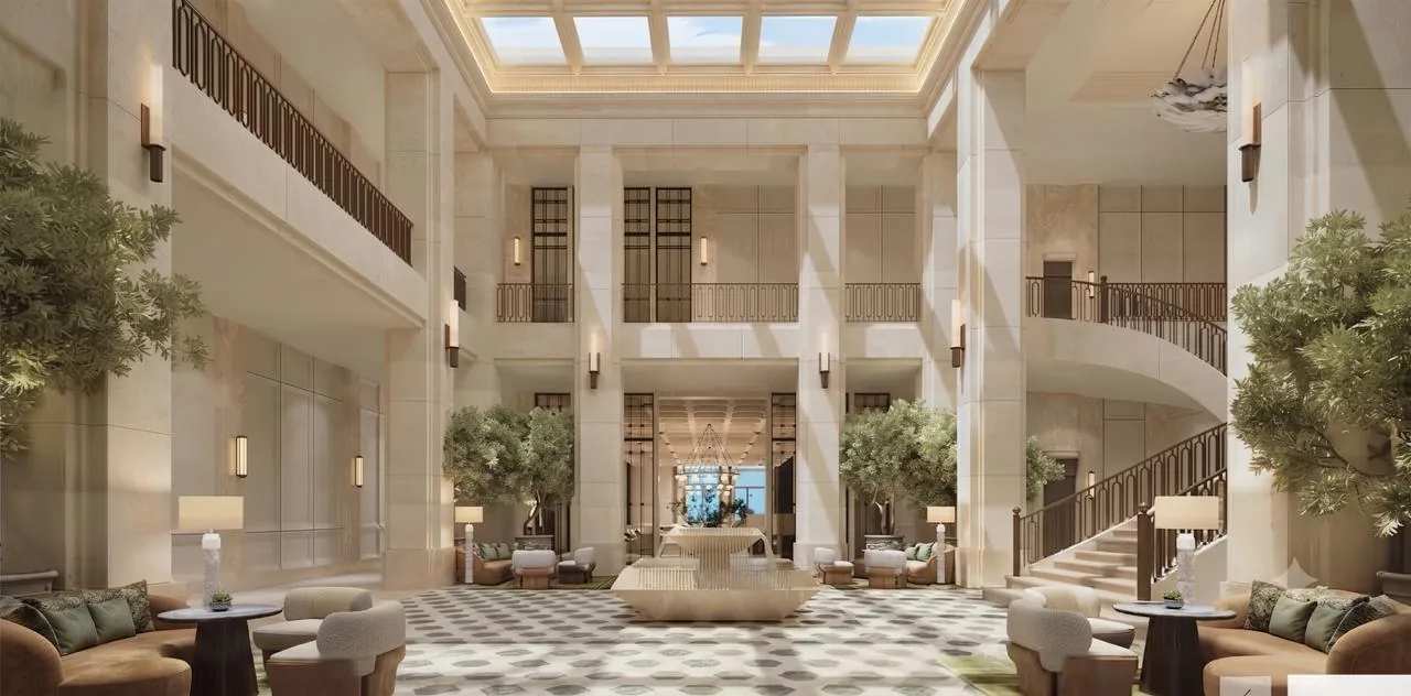 Skylit double-height arrival lobby atrium at Lodha Beaumont Estate