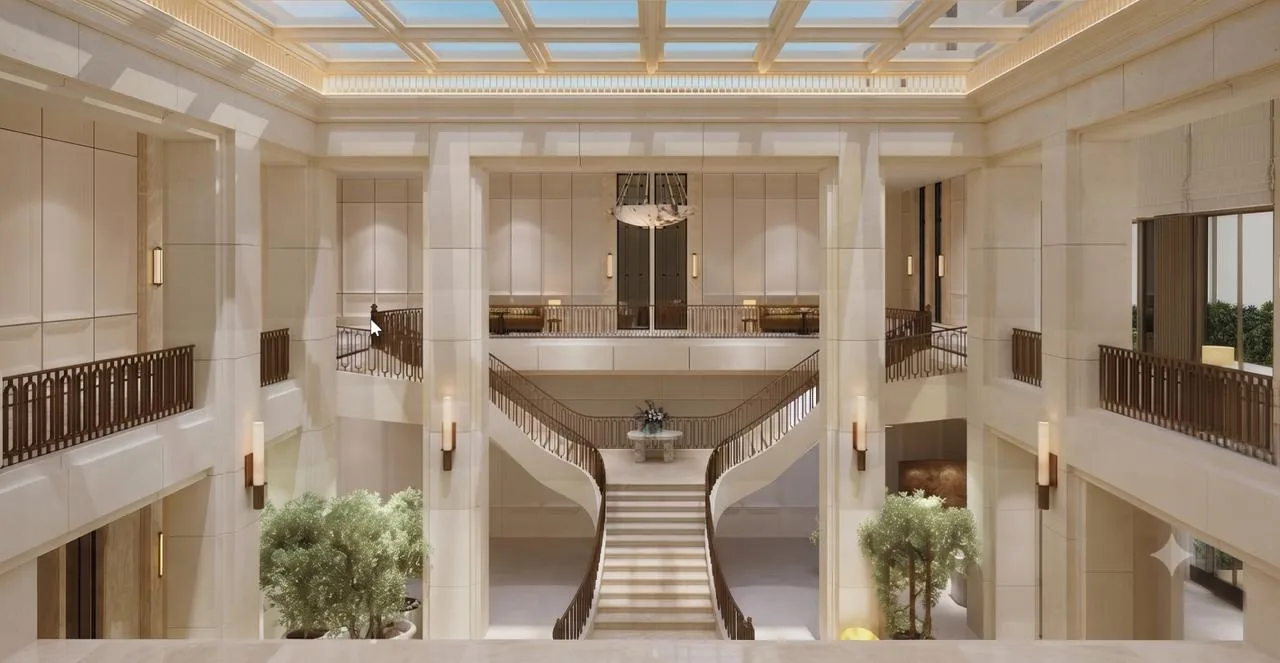 Grand clubhouse atrium with a sweeping double staircase at Lodha Beaumont Estate